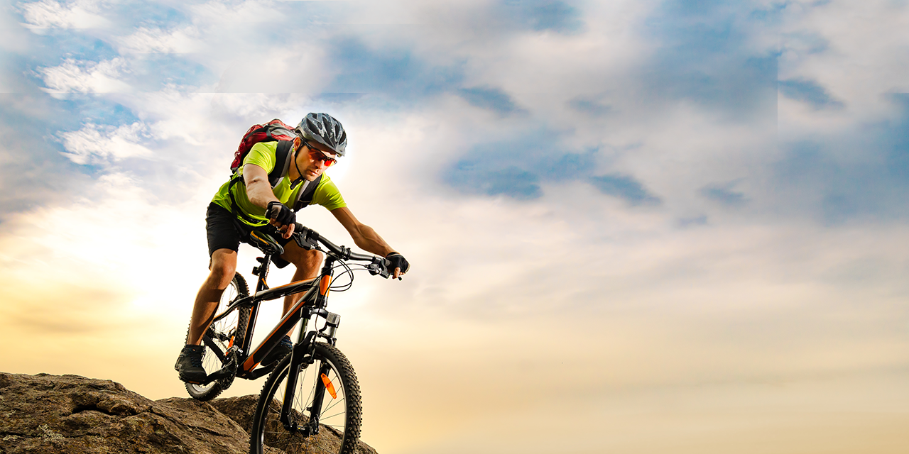 Mountain biker at dusk on a bluff.