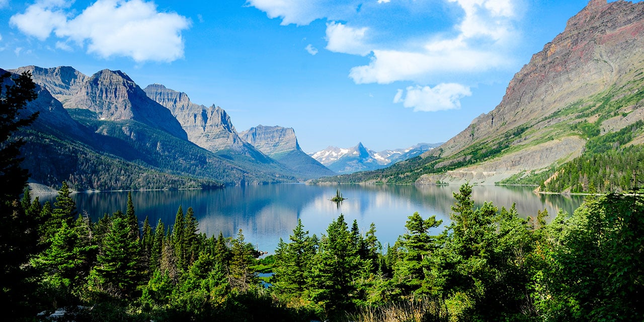 Mountains and trees next to a body of water